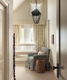 a room with two chairs and a lamp hanging from the ceiling