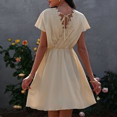 The Anna-Kaci Dress Is Detailed With A Fun Overlap Tie-Back Design. Features A V Neckline, Solid Color, Flutter Sleeves, Crochet Lace Back Detail, Flowy Skirt, And Above Knee Length. Pair It With Sunnies And A Clutch Bag For A Minimalist Look. Materials: 100% Soft Polyester Measurements: Product Length Is 35"-37" In 4-6-Small | Waist: 25”-26.5” In | Chest: 33”-34.5” In | Hips: 35”-36.5” In 6-8-Medium | Waist: 26.5”-28” In | Chest: 34.5”-36” In | Hips: 36.5”-38” In 8-10-Large | Waist: 28”-29.5” I A-line Dress With Lace Trim For Vacation, Casual V-neck Dress With Lace Patchwork, Elegant Flutter Sleeve Vacation Dresses, Elegant Flutter Sleeve Dress For Vacation, Solid Dresses With Lace Trim For Daywear, Solid Color Dresses With Lace Trim For Daywear, Solid Daywear Dresses With Lace Trim, A-line Mini Dress With Lace Trim For Beach, Casual V-neck Mini Dress With Lace Patchwork