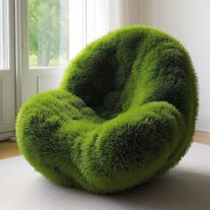 a green chair sitting on top of a white rug in front of a large window