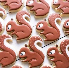 decorated cookies with white and red icing in the shape of animals