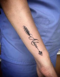 a person with a tattoo on their arm that has an arrow and feather in it