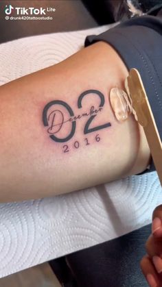 a person with a tattoo on their arm that says, 22 and twenty years ago