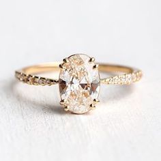 an oval cut engagement ring with diamond accents