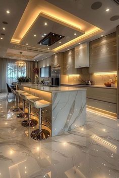 an elegant kitchen with marble counter tops and bar stools in the center is lit by recessed lighting