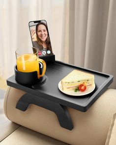 a table with a cell phone on it and a plate of food next to it