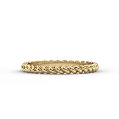 a yellow gold wedding band with twisted design in the middle, on a white background