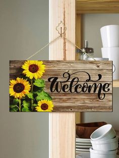 a wooden sign hanging from the side of a door with sunflowers on it