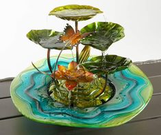 a glass bowl with water and plants in it