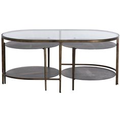 an oval glass table with metal legs and two shelves on each side, against a white background