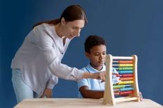 a woman teaching a boy how to play with an abacusk