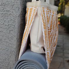 a white and orange bag hanging from the side of a building with a blue pole attached to it