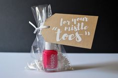 a bottle of nail polish in a bag with a tag that says for your nistle toes