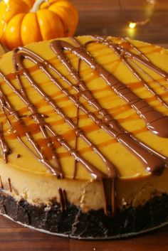 a cheesecake covered in chocolate and caramel drizzled on the top