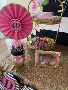 a table topped with pink and gold decorations