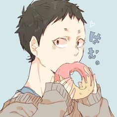 a man holding a doughnut in front of his face