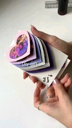 a woman is holding several folded cards in her hand, with the words diy gift ideas written on them