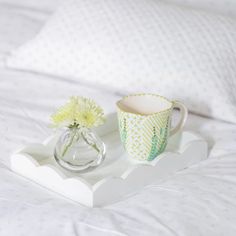 Designed to sit beautifully on any bedside table, coffee table, or sideboard this glossy, white lacquer tray boasts a playful scalloped edge and deep straight sides. A must-have for any home this piece functions wonderfully as a vanity tray, drinks tray, or for displaying small trinkets.DESIGN DETAILS- Cream velvet base with embossed logo- Finished with 20 coats of high gloss lacquer- Hand polished between each coat of lacquerDIMENSIONS: 11 in. x 8 in.CARE- Arrives beautifully packaged and ready Addison Ross, Dinner Tray, Elegant Dinner Party, Drinks Tray, Ottoman Tray, Elegant Dinner, Serving Drinks, Table Coffee, Vanity Tray