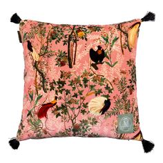 a pink pillow with birds and flowers on the front, along with tassels