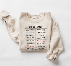 "Show off your love for books and vintage charm with our cozy 'Due Date Library Card' sweatshirt! ORDERING INFO  ALL ITEMS ARE SOLD SEPARATELY  HOW TO:  1. Choose the SWEATSHIRT COLOR from the 1st dropdown. If you would like a color not shown please message us. 2. Choose the SWEATSHIRT SIZE from the 2nd dropdown. 3. Add each item to the cart.  💥If you are purchasing more than one sweatshirt, complete this process as many times as needed.  VERY IMPORTANT 💥 SIZING AND FABRIC INFO: -- Unisex Sweatshirt -- Sizing Info: These sweatshirts are a unisex style meaning they tend to run wider/longer than women's styles might; however, if you are looking for the oversize look, you might consider sizing up as they are true to size. Make sure to use the measurements chart to determine the best size fo Retro Library, Library Shirt, Gift For Librarian, Librarian Style, Librarian Shirt, Gifts For Librarians, Funny Teacher, Library Card, Measurement Chart