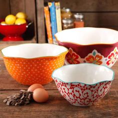 three bowls and an egg on a wooden table