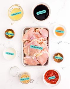 ingredients for chicken wings laid out on a white counter top, including sauces and seasonings