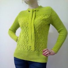 a woman is wearing a bright green sweater