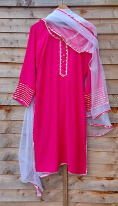 Hot pink suit set for women.  Set of 3 kurta, payjama and dupatta.  Suitable for festive wear like for rakhi, janmasthmi and diwali.  Can be matched as mum and daughter outfit. Sizes available -  THESE ARE GARMENT MEASUREMENTS (IN INCHES) Size 8 - XS - Bust 32, Waist 24 Size 10 - S - Bust 34, Waist 26 Size 12- M - Bust 36, Waist 28 Size 14 - L - Bust 38, Waist 30 Size 16 - XL - Bust 40, Waist 32 Size 18 - XXL -Bust 42, Waist 34 Disclaimer - This product is made to order. Product colour may sligh Pink Gota Work Sets For Diwali, Pink Straight Kurta Lawn Suit For Eid, Fitted Pink Churidar With Straight Kurta, Pink Unstitched Suit For Eid, Pink Palazzo Set With Gota Work For Festivals, Traditional Pink Lawn Suit For Party, Pink Lawn Suit With Dupatta And Straight Kurta, Festive Pink Lawn Suit With Straight Kurta, Fitted Pink Lawn Suit With Dupatta