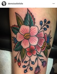 a flower tattoo is shown on the leg