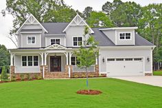 a large house with two garages in the front yard