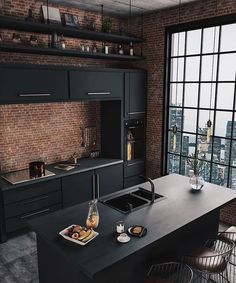 an industrial kitchen with black cabinets and counter tops, along with a large window that looks out onto the city