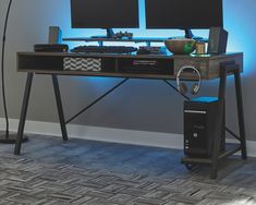 a computer desk with two monitors on it