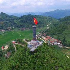 an aerial view of a clock tower on top of a hill in the middle of nowhere