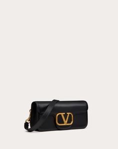 Valentino Garavani Locò calfskin crossbody bag. - Logo and antique brass-finish hardware - Magnetic closure - Open inside pocket - Adjustable and removable shoulder strap - Dimensions: W27xH12xD6 cm - Valentino Garavani logo - Drop length: 50 cm - Made in Italy Designer Baguette Satchel Bag With Gold-tone Hardware, Timeless Crossbody Baguette Bag For Formal Occasions, Timeless Crossbody Baguette Bag For Formal Events, Luxury Baguette Satchel With Palladium Hardware, Classic Travel Baguette Bag With Branded Hardware, High-end Shoulder Flap Bag With Gold-tone Hardware, Formal Crossbody Baguette Bag With Detachable Strap, Luxury Baguette Bag With Palladium Hardware For Everyday Use, Luxury Crossbody Baguette Bag For Business