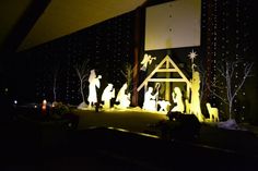 the nativity scene is lit up at night