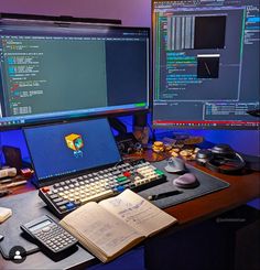 two computer monitors sitting on top of a desk next to a keyboard and calculator