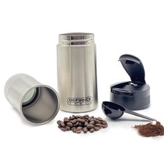 the coffee grinder is next to some beans