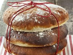 two loaves of bread wrapped in twine on top of each other with red string