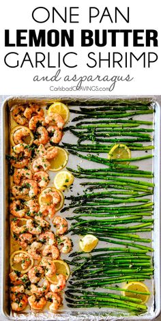 asparagus, lemons and shrimp on a baking sheet