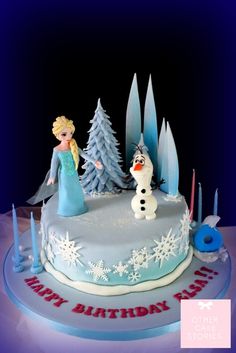 a frozen princess birthday cake with frosting and decorations