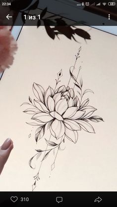 someone is drawing a flower on the paper