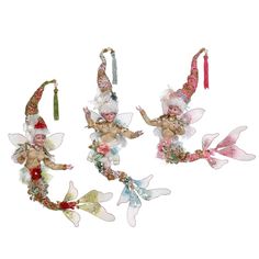 three fairy ornaments hanging from strings on a white background