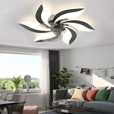 a living room filled with furniture and a ceiling fan in the middle of the room