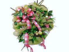 a wreath with pink and green flowers on it