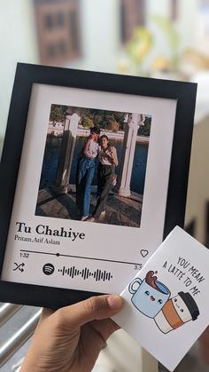 a person holding up a card with an image of a man and woman on it