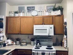 a kitchen with wooden cabinets and white appliances