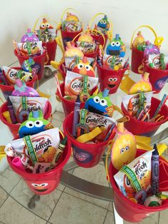 a bunch of buckets filled with candy sitting on top of a table