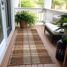 a brown and white rug sitting on top of a wooden floor next to a window