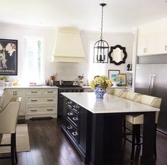 a large kitchen with an island in the middle