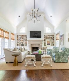 a living room filled with furniture and a fire place in the middle of a room