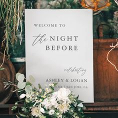 a sign that says welcome to the night before with flowers and greenery in front of it